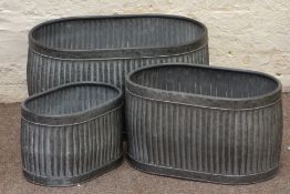 Three galvanized metal oval graduating dolly tub type planters,