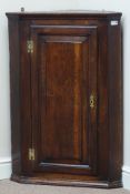 Late 18th century oak corner cabinet, single fielded panelled door, two shaped shelves,