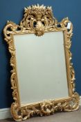 Ornate hand carved gilt wood wall mirror with flower basket pediment, bevelled glass, W92cm,