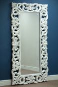 Bevelled edge wall mirror in rectangular white painted open carved frame,