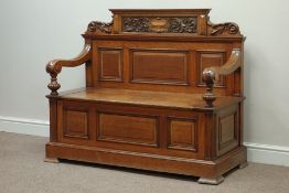 Edwardian golden oak hall bench with fielded panels, the back with leaf carved dentil cresting,