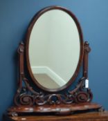 Victorian mahogany oval swing dressing table mirror, serpentine front, carved scrolls, W90cm,