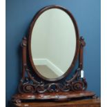 Victorian mahogany oval swing dressing table mirror, serpentine front, carved scrolls, W90cm,