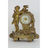 Late 19th century ormolu mantel clock, floral swag and putto holding bird aloft, jeweled bezel,