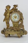 Late 19th century ormolu mantel clock, floral swag and putto holding bird aloft, jeweled bezel,