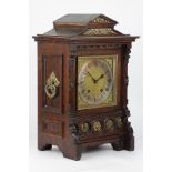 Late 19th century Gothic style oak cased mantle clock with brass mounts,