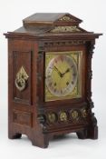 Late 19th century Gothic style oak cased mantle clock with brass mounts,