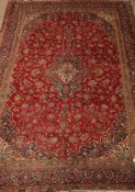 Persian Kashan red ground rug carpet floral field around a central medallion, multiple border,