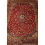 Persian Kashan red ground rug carpet floral field around a central medallion, multiple border,