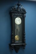 Large Victorian Vienna ebonised wall clock with urn cresting, circular dial with subsidiary seconds,