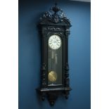 Large Victorian Vienna ebonised wall clock with urn cresting, circular dial with subsidiary seconds,