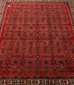 Hamadan red ground rug carpet field repeating geometric motifs within a chevron and stylized floral