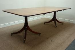 Regency style mahogany twin pillar dining table, eight reeded splayed legs, brass cups and castors,