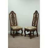 Pair oak Carolean style hall chairs, heavily carved with scrolls and foliage,