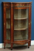 Late 19th century serpentine satinwood display cabinet, painted in Neo Classical style with cherubs,