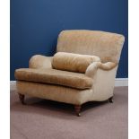 Howard & Sons armchair, turned walnut front feet, upholstered in pale gold cover,