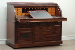 Late Victorian mahogany cylinder top desk, multiple drawers and carved panelled cupboard,