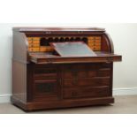 Late Victorian mahogany cylinder top desk, multiple drawers and carved panelled cupboard,