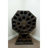 Eastern hardwood octagonal wine rack, tooled metal decoration, W78cm, H120cm,