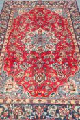 Persian Tabriz red ground, floral design with central medallion,