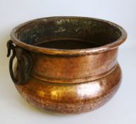 Beaten copper circular Cauldron with cast iron handles,