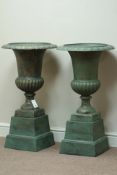 Pair Victorian style copper finish cast iron urns on plinths, D47cm,