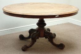 Victorian inlaid walnut loo table, oval tilt top, carved base with four splayed legs, 145cm x 108cm,