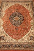 Large Persian Kerman rug carpet, blue centre with medallion on a rust field of floral designs,