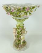 Early 20th Century centrepiece with floral decoration supported by three Cherubs,