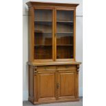 Edwardian walnut bookcase on cupboard,