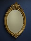 Victorian gilt wood and gesso oval mirror, bevelled glass.