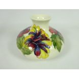 Moorcroft Hibiscus pattern white ground squat vase, impressed marks & Queen Mary paper label,