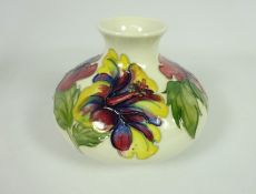 Moorcroft Hibiscus pattern white ground squat vase, impressed marks & Queen Mary paper label,