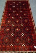 Persian red and blue ground rug, repeating motif design,