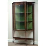 Edwardian mahogany serpentine display cabinet, curved glass panels,