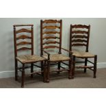 Three early 19th century country elm and oak ladder back chairs with rush seats Condition