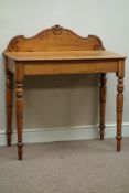 Early 20th century oak side table, shaped carved back, on turned base, W87cm, H96cm,