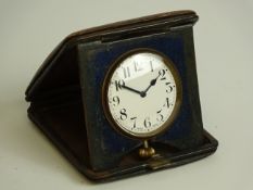 Three early 20th century travelling clocks and another travelling clock with thermometer CLOCKS &