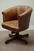 Early 20th century oak framed tub shaped swivel office chair, upholstered in antique leather,