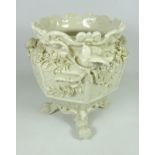 Early 20th Century Belleek jardiniere with floral encrusted decoration raised of four scrolling