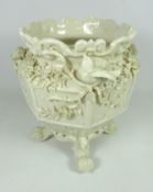 Early 20th Century Belleek jardiniere with floral encrusted decoration raised of four scrolling