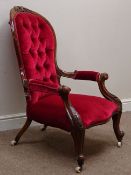 Victorian walnut open arm spoon back armchair, upholstered in buttoned red velvet,