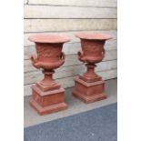 Pair large campana-shaped garden urns, body with scrolling foliage centred with flowers,