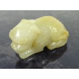 Chinese pale Celadon jade carving of a recumbent lion - dog, L6.