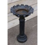 Black painted cast iron centre piece planter, with ribbed rim and gadroon moulding, fluted column,