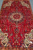 Persian Tabriz red ground rug, large central medallion,