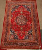 Persian Kashan red ground rug, large central medallion, Heretti boarder,