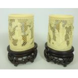 Pair of late 19th / early 20th Century Cantonese carved and pierced ivory tusk vases on carved wood