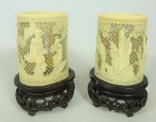 Pair of late 19th / early 20th Century Cantonese carved and pierced ivory tusk vases on carved wood
