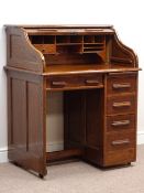 Early 20th century oak single pedestal roll top desk, three drawers and fitted interior, W92cm,